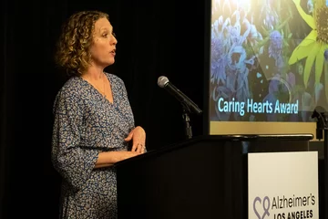 Monica Moore presenting the Caring Hearts Award at the Alzheimer's Lols Angeles Visionary Women’s Tea.